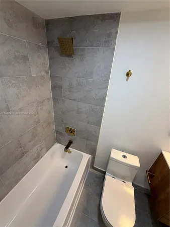 a bathroom with a sink mirror toilet and bathtub