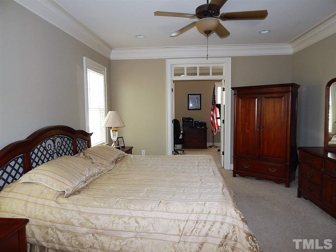 32 North Sunset Ridge Drive Willow Spring, NC 27592 - Photo 10 of 25 a bedroom with a bed and a chandelier