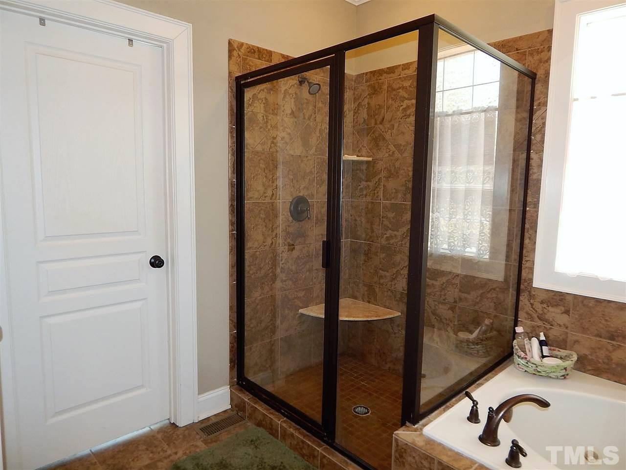 32 North Sunset Ridge Drive Willow Spring, NC 27592 - Photo 12 of 25 a bathroom with a sink and a shower