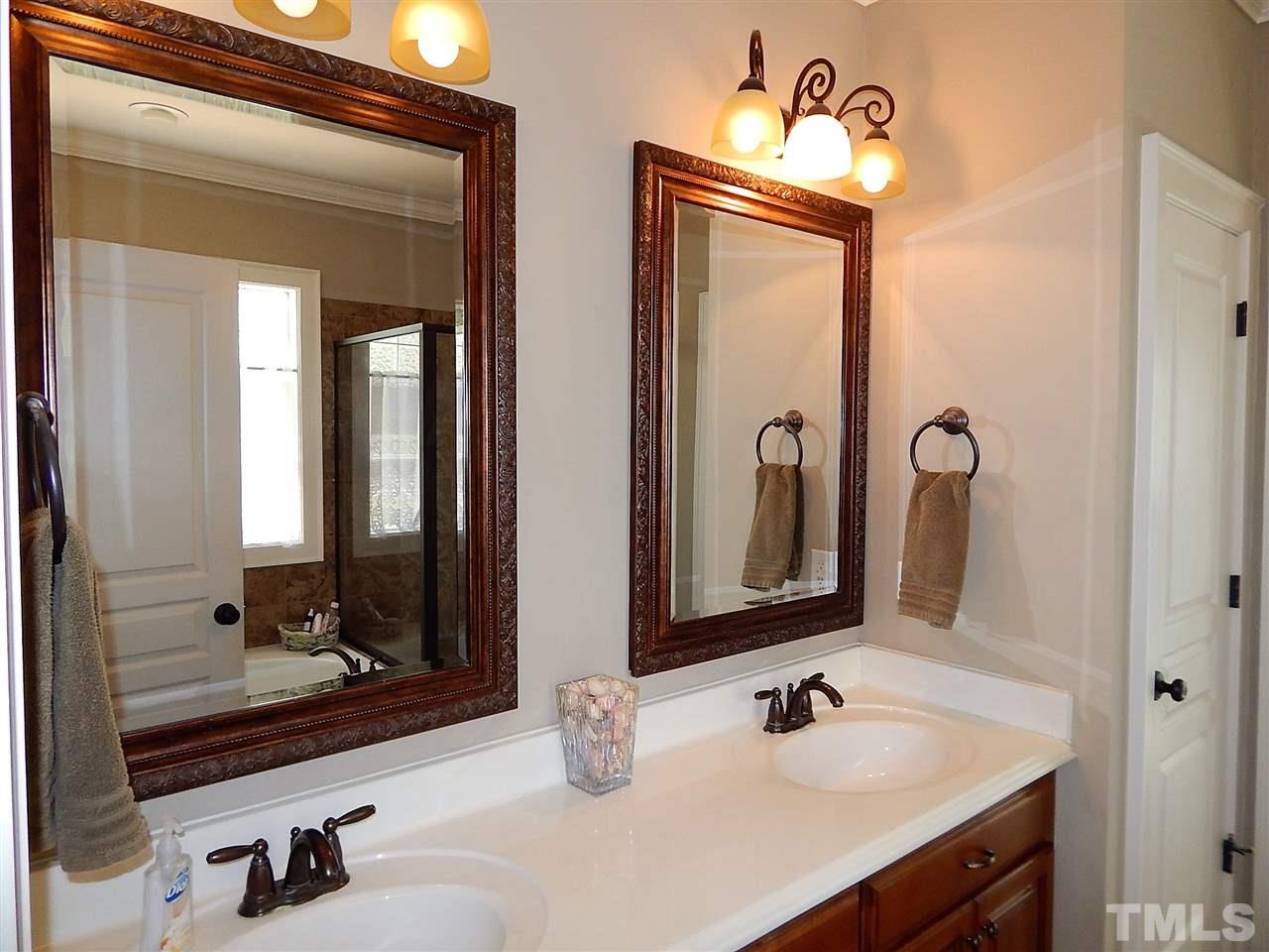 32 North Sunset Ridge Drive Willow Spring, NC 27592 - Photo 13 of 25 a bathroom with a sink and a mirror
