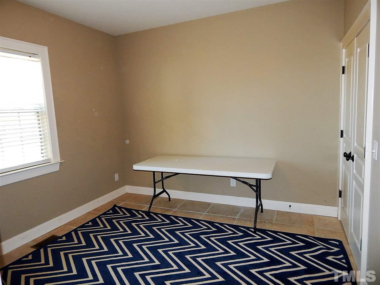 32 North Sunset Ridge Drive Willow Spring, NC 27592 - Photo 14 of 25 a room with wooden floor and a window