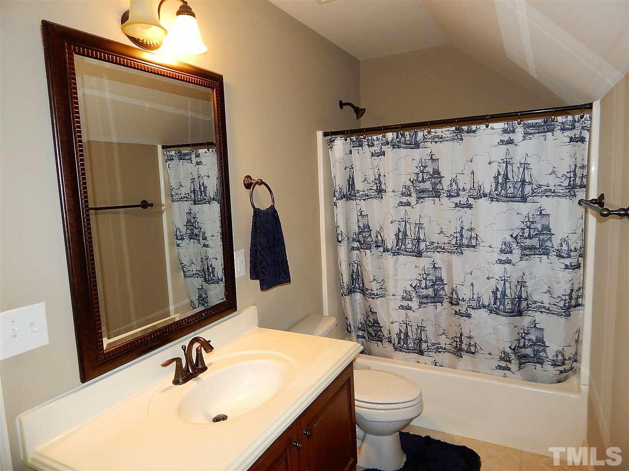 32 North Sunset Ridge Drive Willow Spring, NC 27592 - Photo 17 of 25 a bathroom with a sink and a mirror