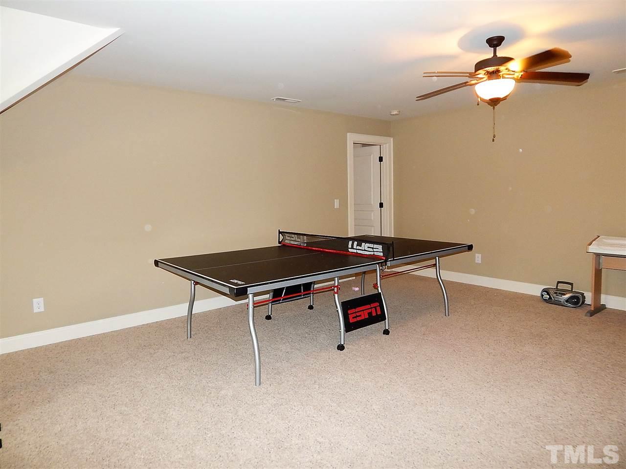 32 North Sunset Ridge Drive Willow Spring, NC 27592 - Photo 20 of 25 a room with gym equipment and a chandelier