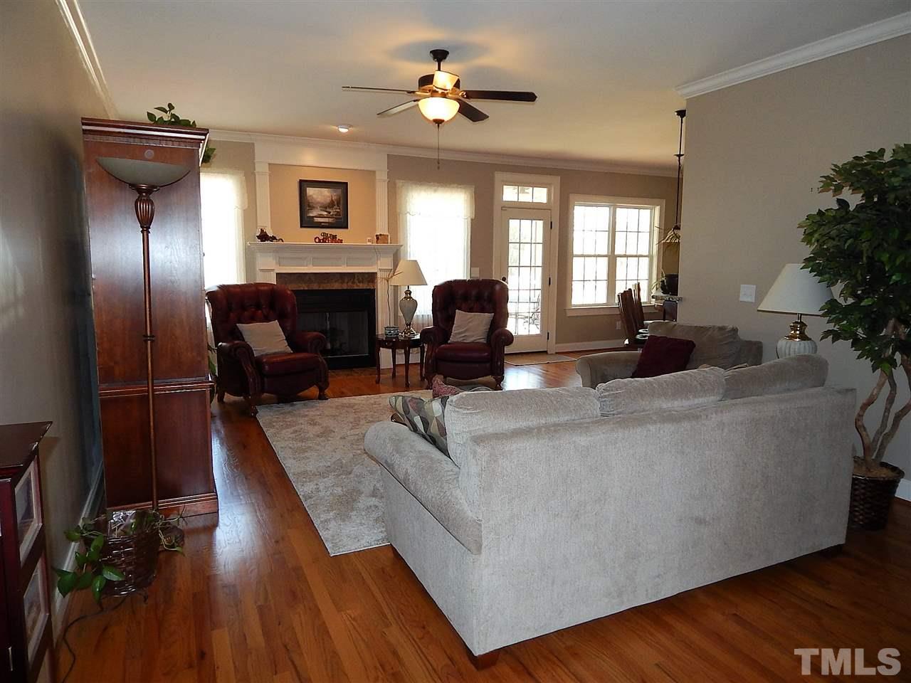 32 North Sunset Ridge Drive Willow Spring, NC 27592 - Photo 25 of 25 a living room with furniture fireplace and potted plants