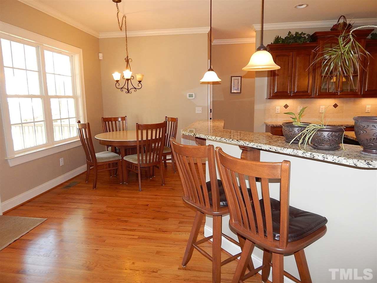 32 North Sunset Ridge Drive Willow Spring, NC 27592 - Photo 9 of 25 a dining room with furniture a chandelier and wooden floor