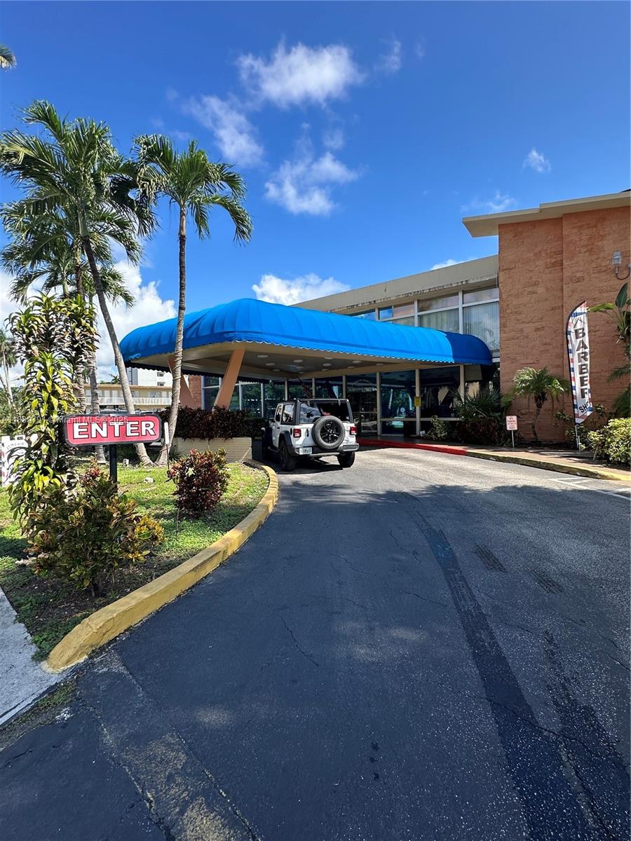 26 Diplomat Parkway, Unit 2248 Hallandale Beach, FL 33009 - Photo 5 of 8 a view of a chairs and tables in the patio
