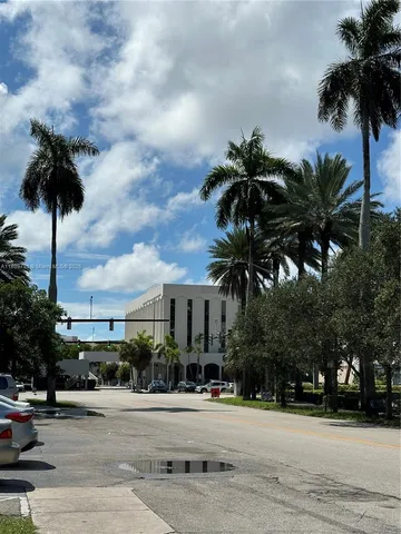 a palm tree sitting in front of a house