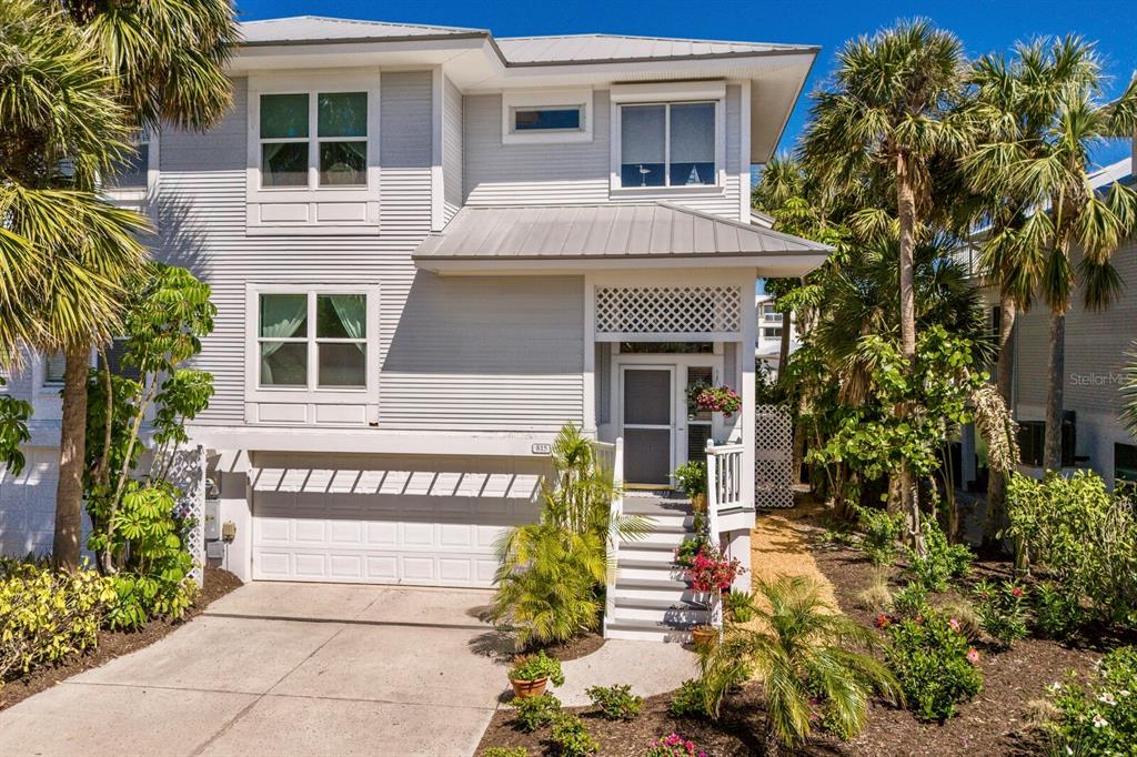 815 South Harbor Drive Boca Grande, FL 33921 - Photo 26 of 74 a view of a house with potted plants and a tree