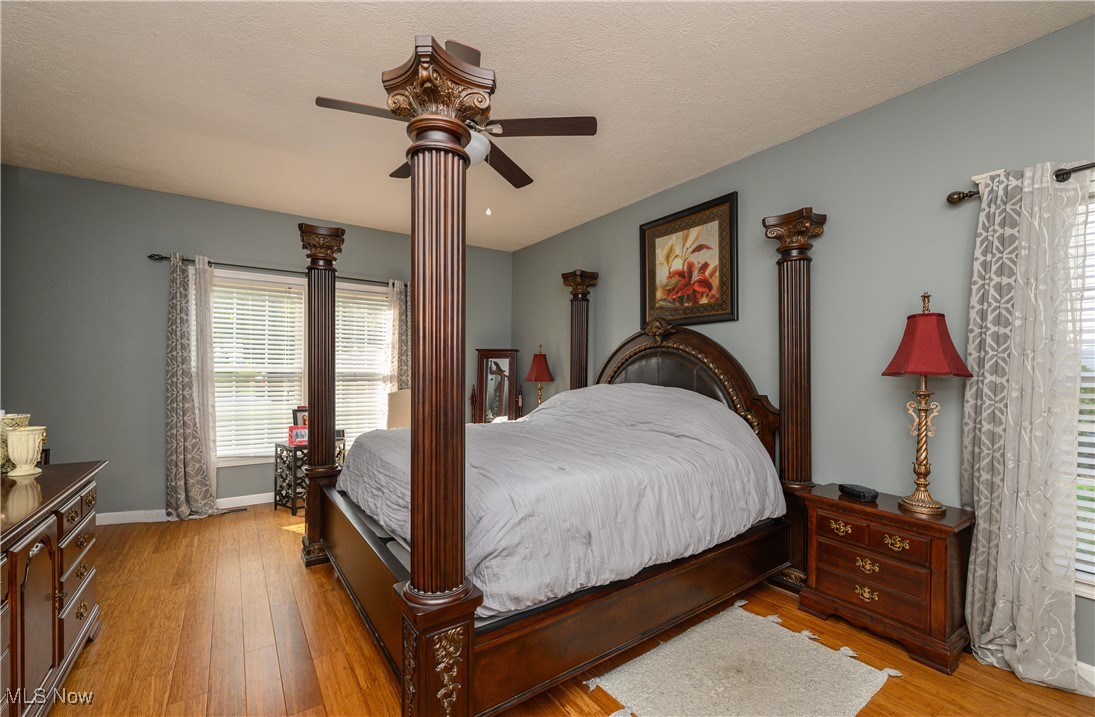 6986 Sweetwater Road Northeast Canton, OH 44721 - Photo 12 of 36 Bedroom with ceiling fan and light hardwood / wood-style floors