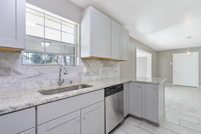 a view of an empty room with windows