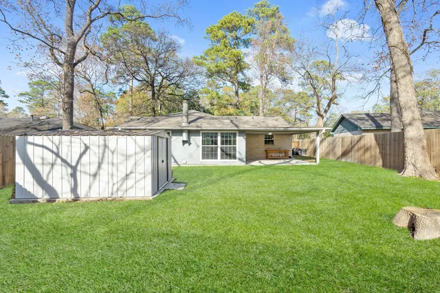a backyard of a house with table and chairs