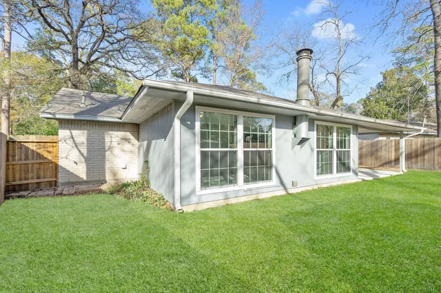 a view of a yard with a house and large trees