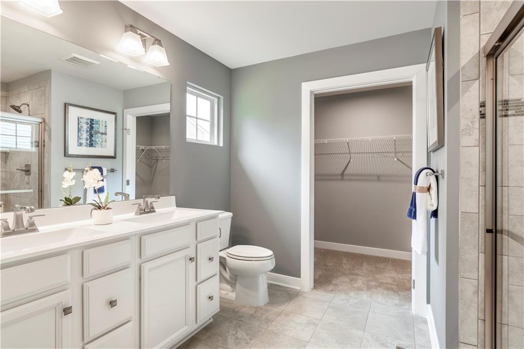 844 Ashley Road Gibsonia, PA 15044 - Photo 13 of 16 a spacious bathroom with a toilet sink and a mirror