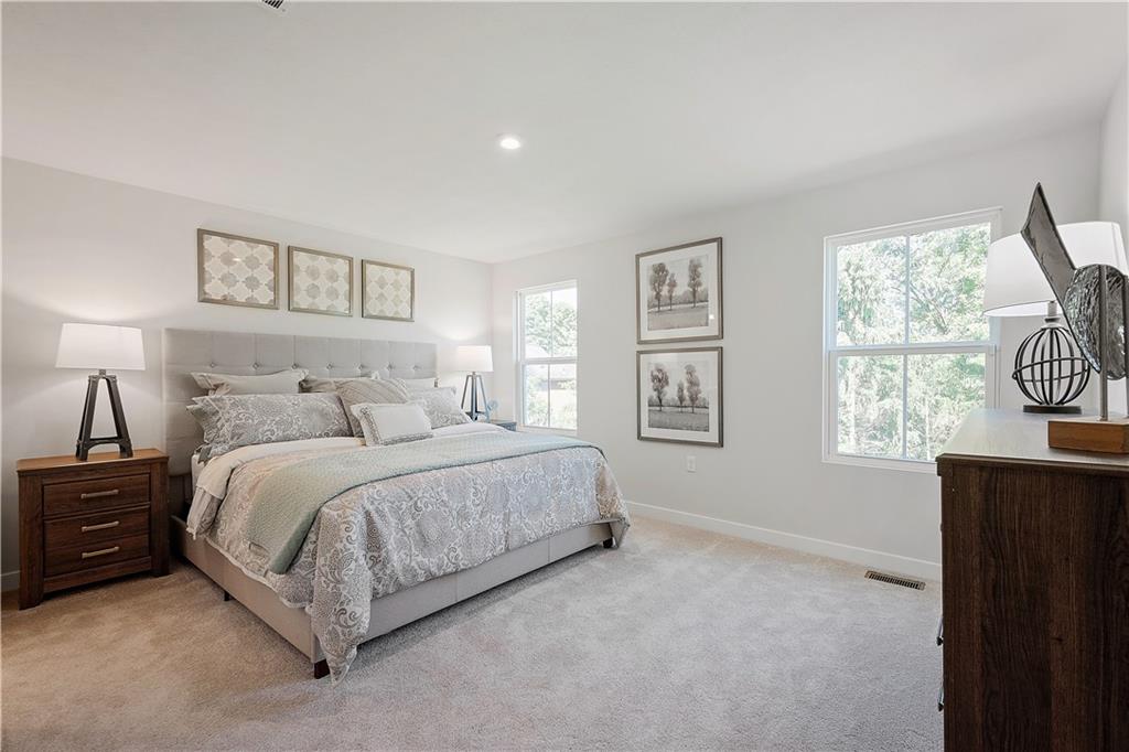 844 Ashley Road Gibsonia, PA 15044 - Photo 9 of 16 a spacious bedroom with a bed and a window