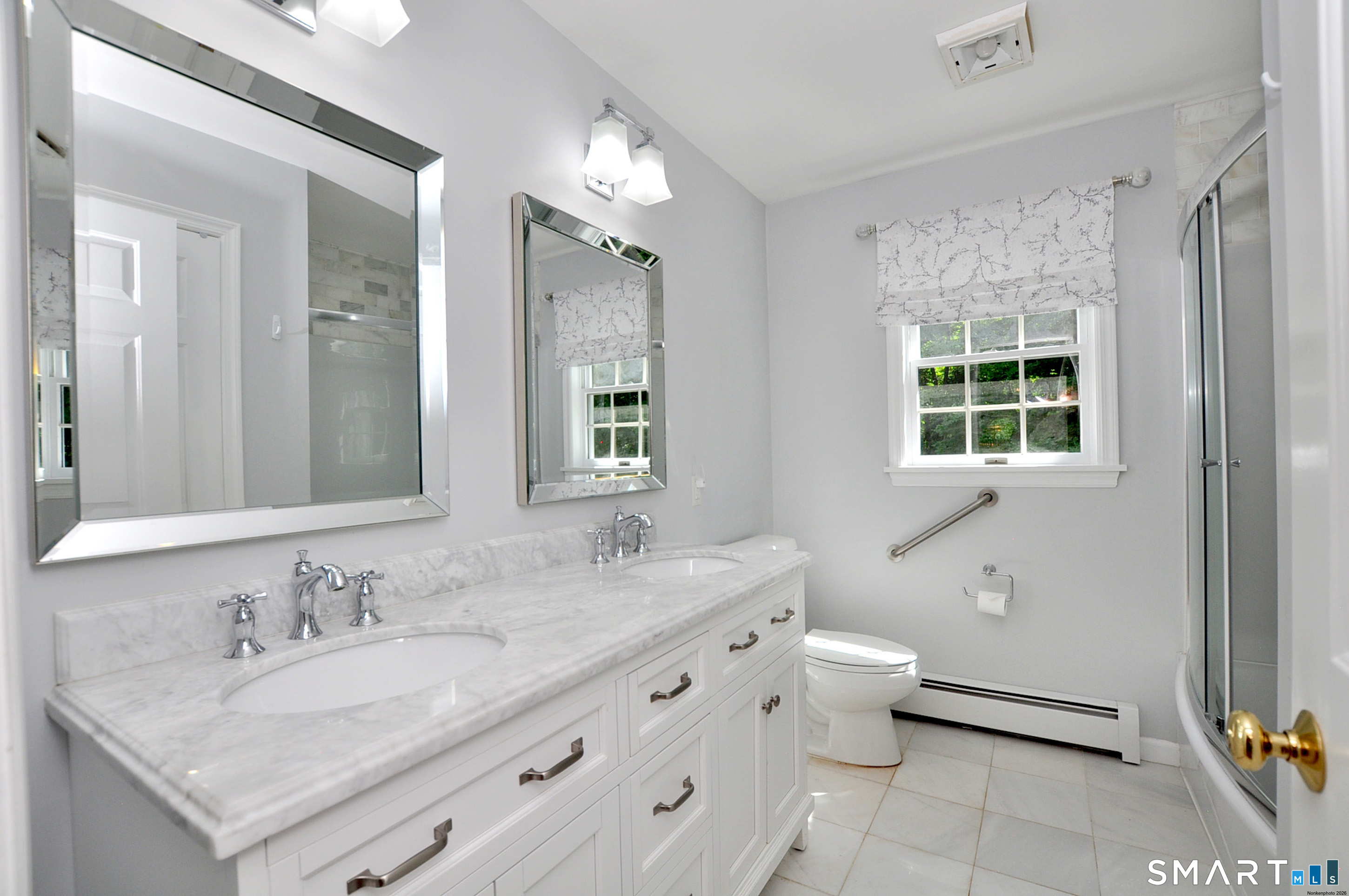 12 Revere Road Bridgewater, CT 06752 - Photo 33 of 40 a bathroom with a granite countertop sink a toilet a mirror and a window