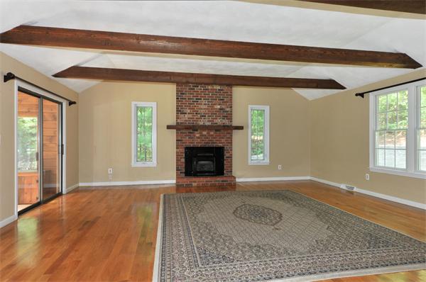 138 Rattlesnake Hill Road Andover, MA 01810 - Photo 3 of 17 a view of an empty room with wooden floor fireplace and a window