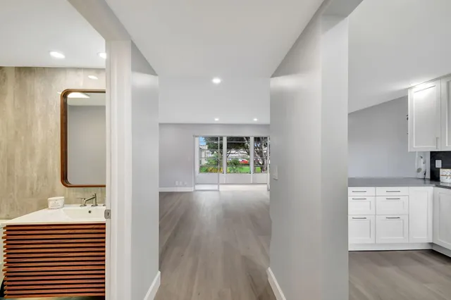 a view of a kitchen cabinets a sink and wooden floor