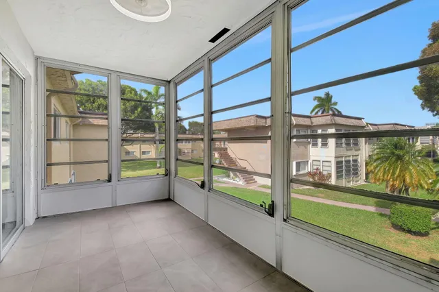 a view of an empty room with a floor to ceiling window