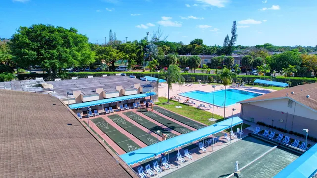 a view of a tennis ground with large trees