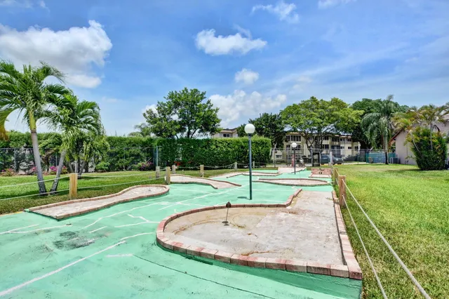 a swimming pool with lots of tress in front of it