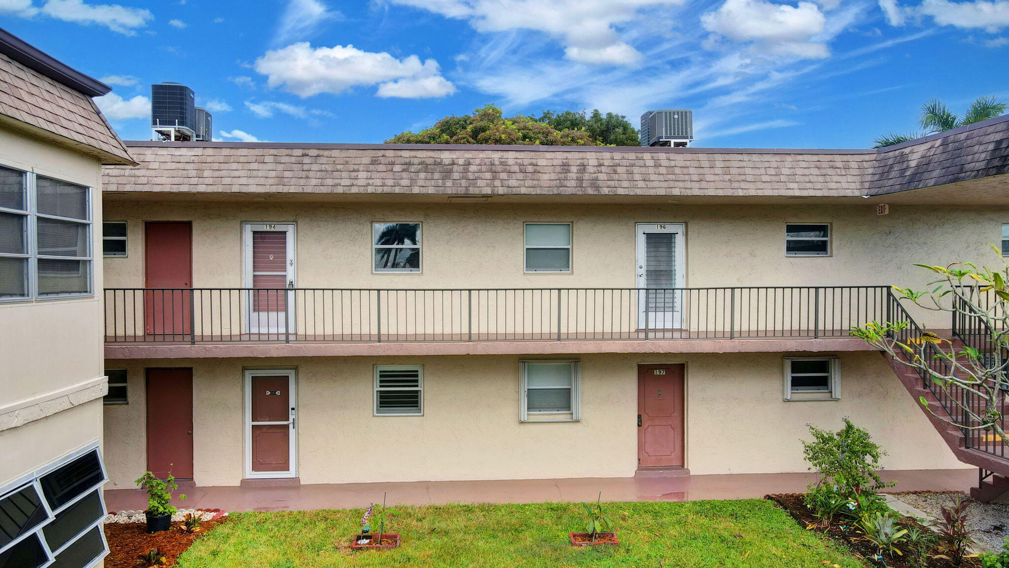 702 Lori Drive, Unit 194 Palm Springs, FL 33461 - Photo 32 of 41 a view of a house with wooden deck and furniture