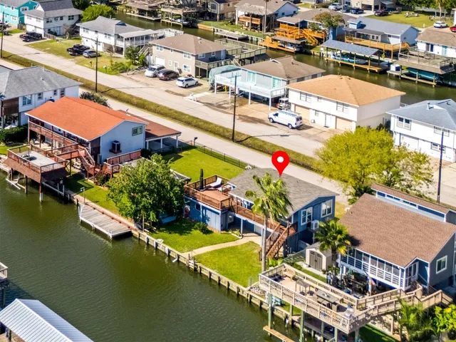 an aerial view of a house with a swimming pool patio and outdoor seating