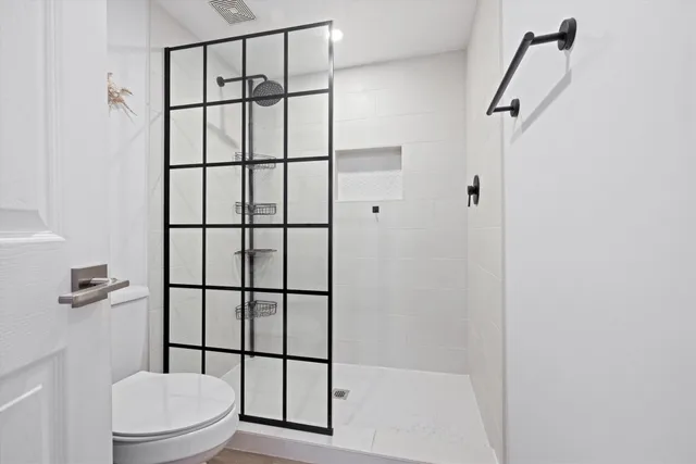a bathroom with a toilet and a shower