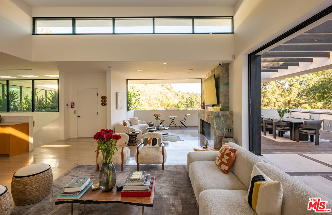 7681 Willow Glen Road Los Angeles, CA 90046 - Photo 11 of 71 a living room with furniture and a large window