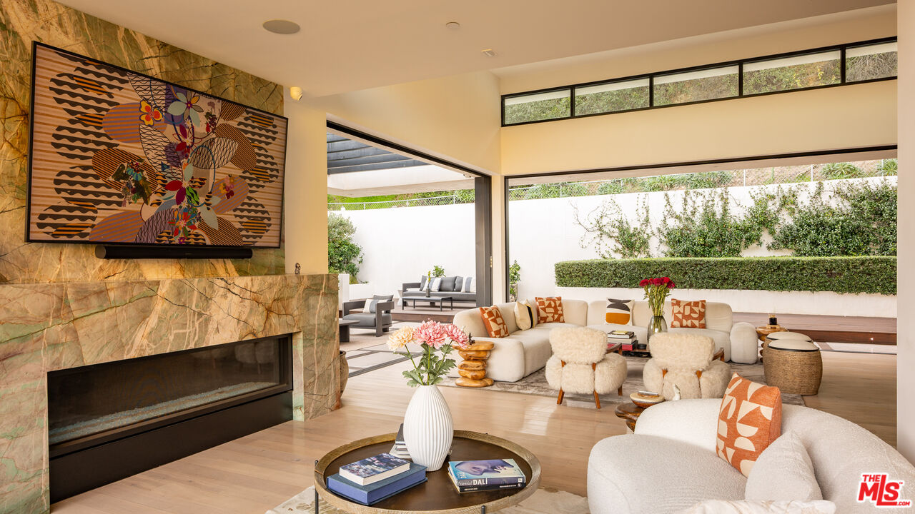 7681 Willow Glen Road Los Angeles, CA 90046 - Photo 13 of 71 a living room with furniture a fireplace and a large window