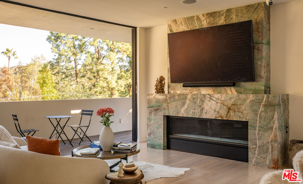 7681 Willow Glen Road Los Angeles, CA 90046 - Photo 14 of 71 a living room with fireplace furniture and a flat screen tv