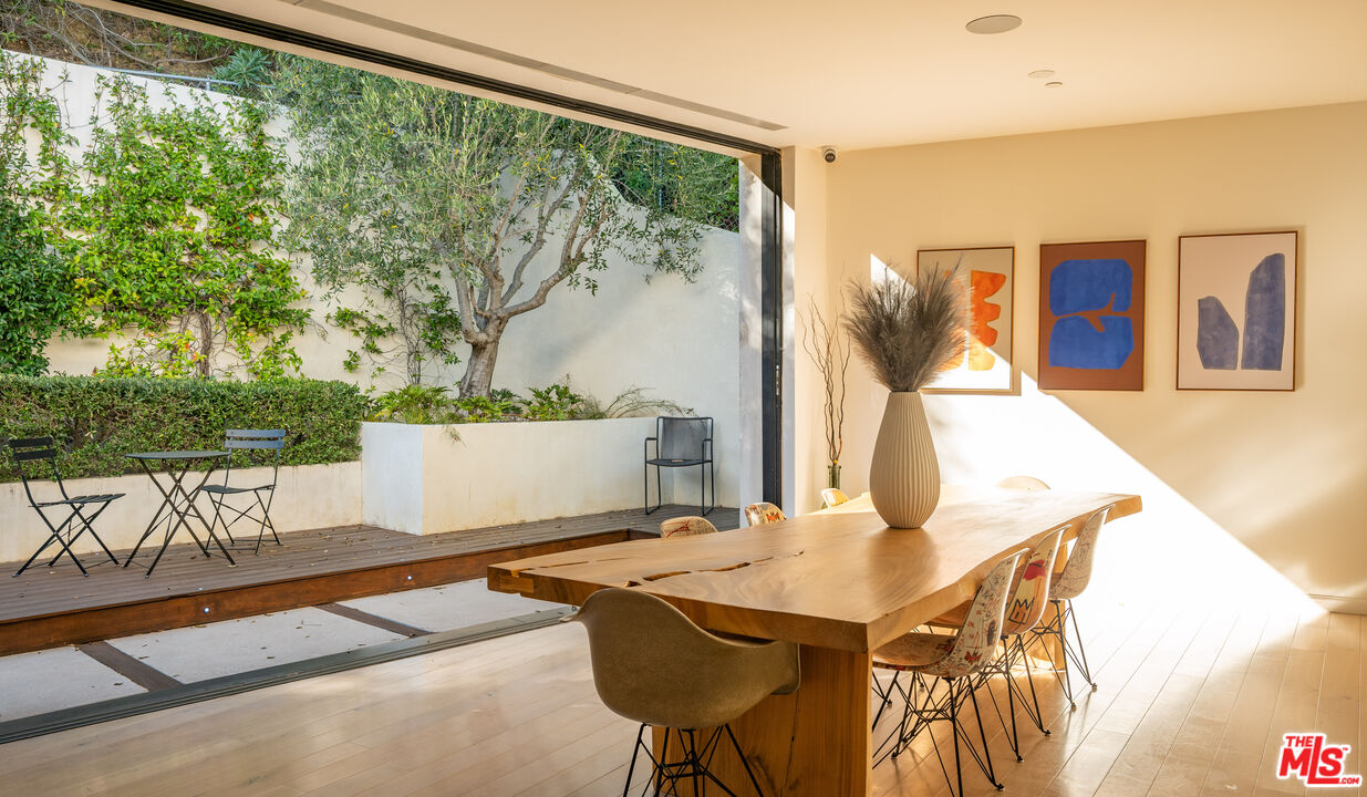 7681 Willow Glen Road Los Angeles, CA 90046 - Photo 17 of 71 a view of a dining room with furniture and a floor to ceiling window