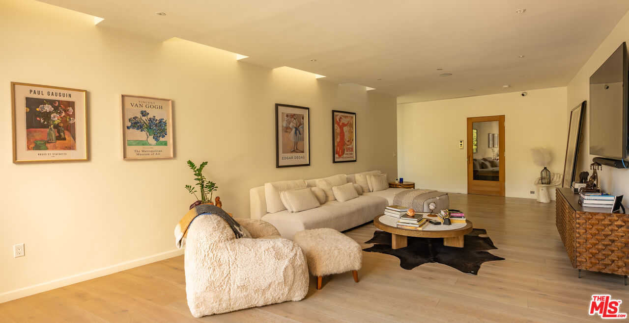 7681 Willow Glen Road Los Angeles, CA 90046 - Photo 29 of 71 a living room with furniture and wooden floor