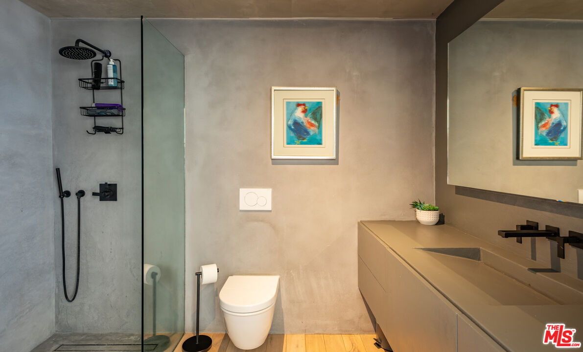 7681 Willow Glen Road Los Angeles, CA 90046 - Photo 31 of 71 a bathroom with a granite countertop sink toilet and shower