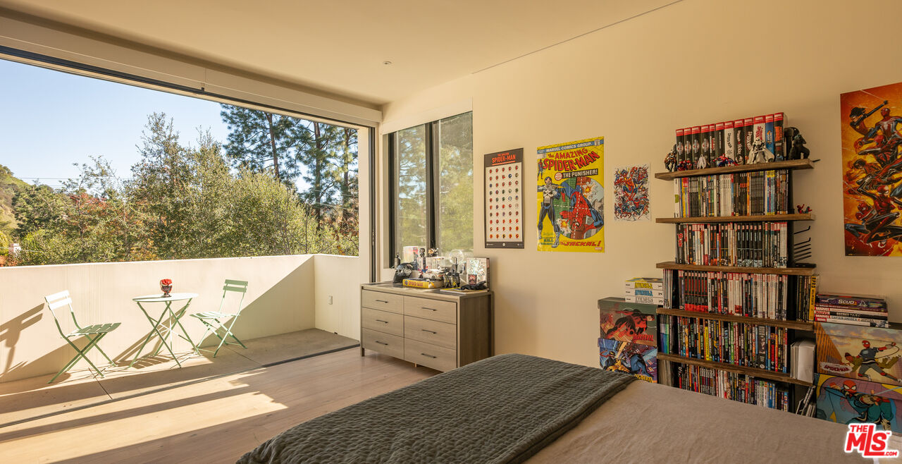7681 Willow Glen Road Los Angeles, CA 90046 - Photo 32 of 71 a living room with lots of furniture and a floor to ceiling window