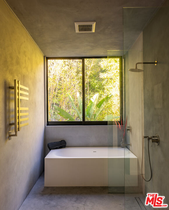 7681 Willow Glen Road Los Angeles, CA 90046 - Photo 42 of 71 a bath tub sitting in a bathroom next to a window