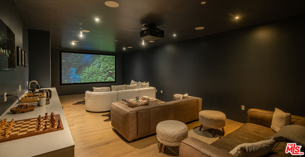 7681 Willow Glen Road Los Angeles, CA 90046 - Photo 48 of 71 a living room with furniture and a flat screen tv