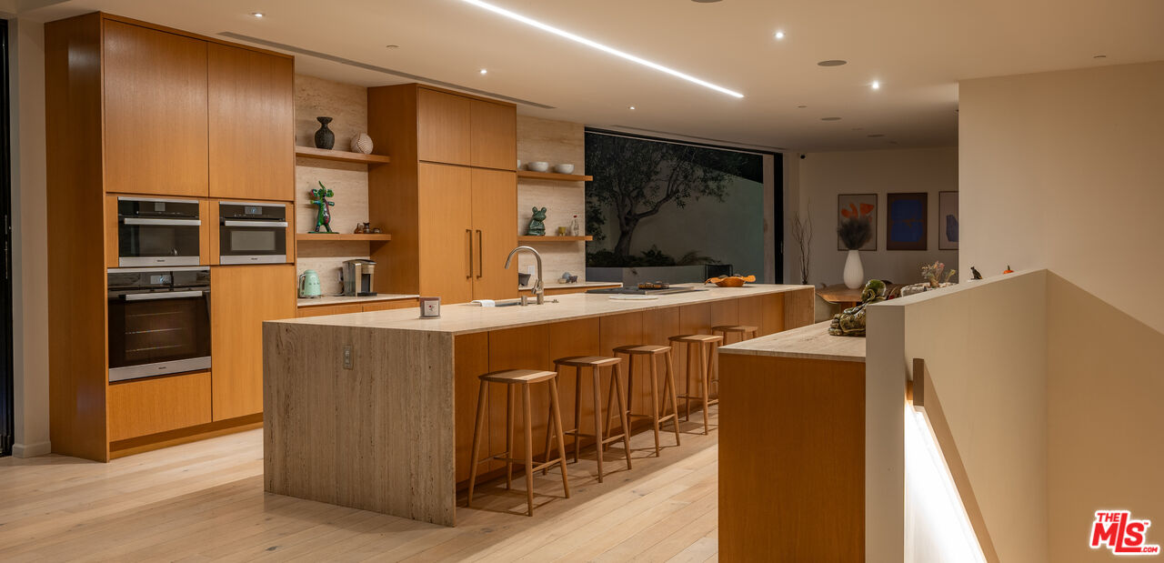 7681 Willow Glen Road Los Angeles, CA 90046 - Photo 52 of 71 a kitchen with stainless steel appliances granite countertop a refrigerator a oven and a sink