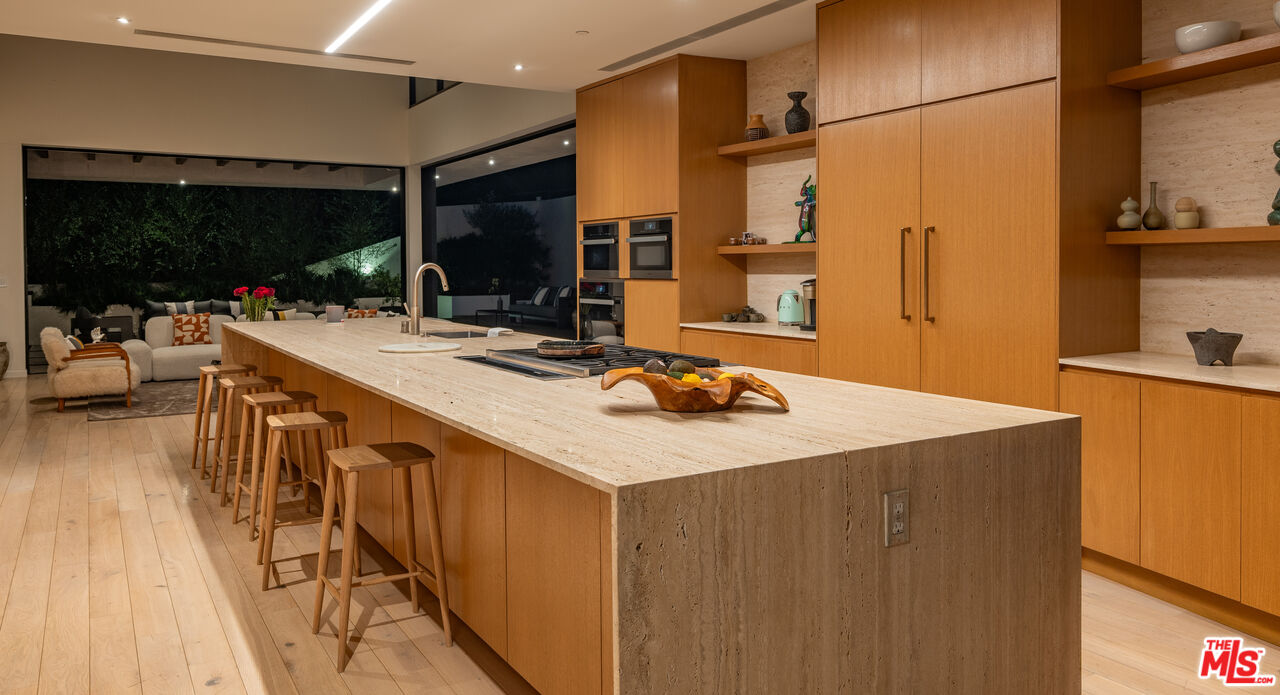7681 Willow Glen Road Los Angeles, CA 90046 - Photo 54 of 71 a kitchen with stainless steel appliances a sink and a refrigerator