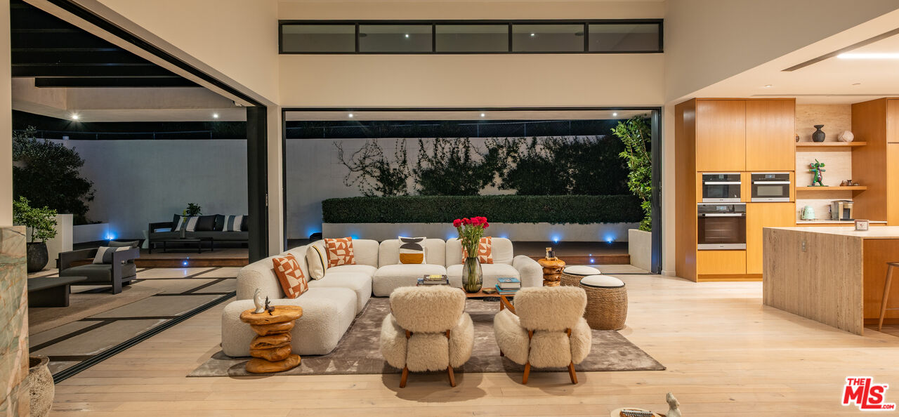 7681 Willow Glen Road Los Angeles, CA 90046 - Photo 55 of 71 a living room with patio furniture and a floor to ceiling window