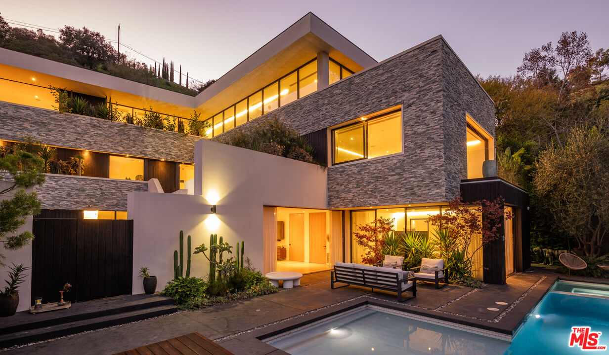7681 Willow Glen Road Los Angeles, CA 90046 - Photo 57 of 71 a view of a building with a floor to ceiling windows and a basket ball poll