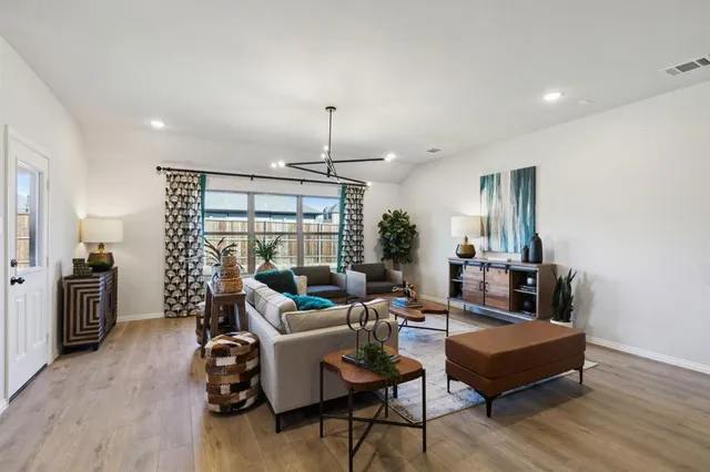 a living room with furniture and a wooden floor