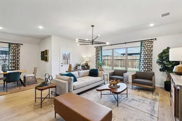a living room with furniture and a chandelier