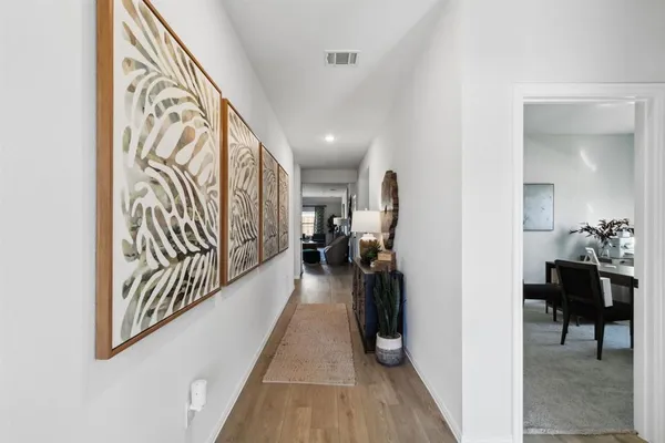 a view of a hallway and a livingroom with furniture