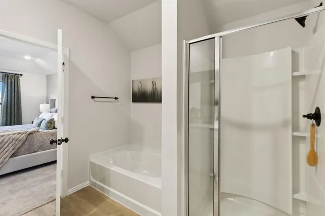 a bathroom with a tub shower vanity and a sink