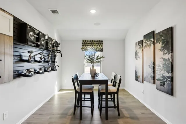 a dining room with furniture and wooden floor