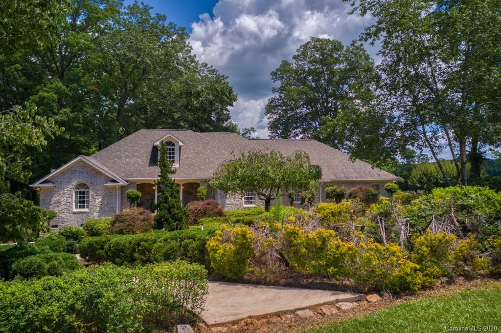 77 Club Road Tryon, NC 28782 - Photo 1 of 35 a aerial view of a house with a yard and large trees