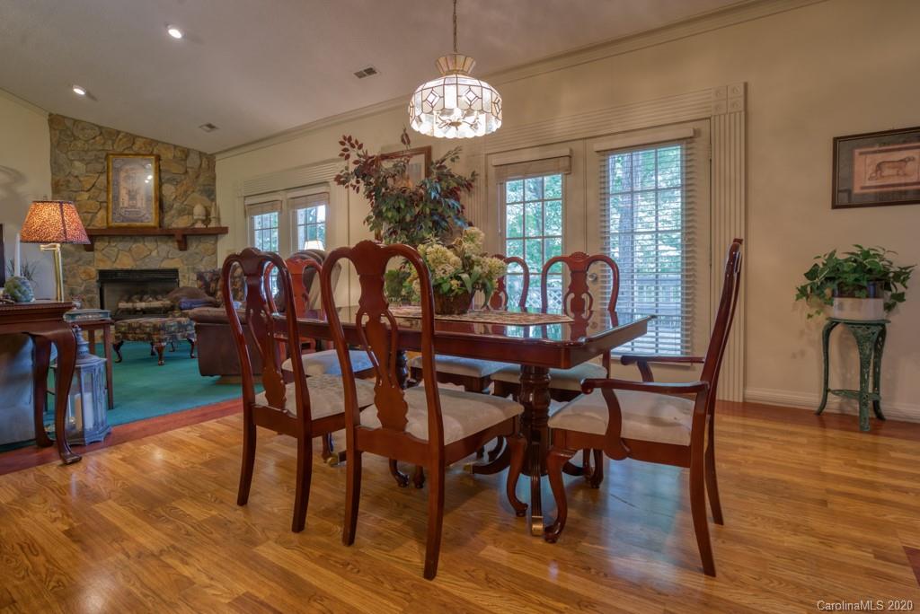 77 Club Road Tryon, NC 28782 - Photo 13 of 35 a view of a dining room with furniture window and wooden floor