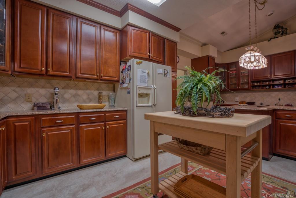 77 Club Road Tryon, NC 28782 - Photo 20 of 35 a kitchen with granite countertop stainless steel appliances stove microwave and cabinets