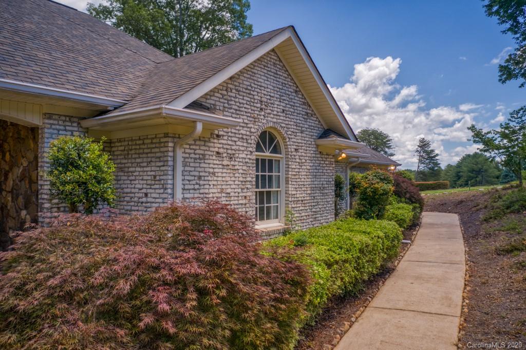 77 Club Road Tryon, NC 28782 - Photo 3 of 35 a front view of a house with garden