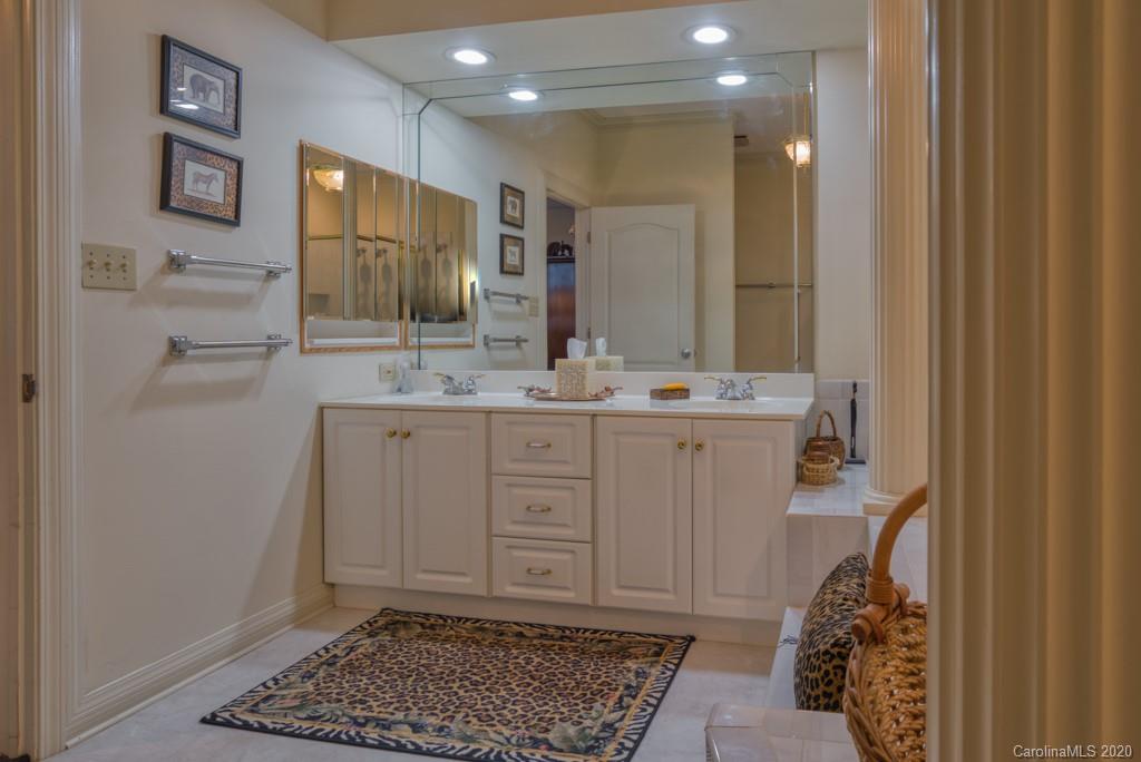 77 Club Road Tryon, NC 28782 - Photo 25 of 35 a bathroom with a sink a toilet and mirror